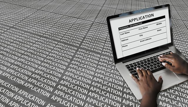 Job applicant editing resume with digital skills section open on laptop