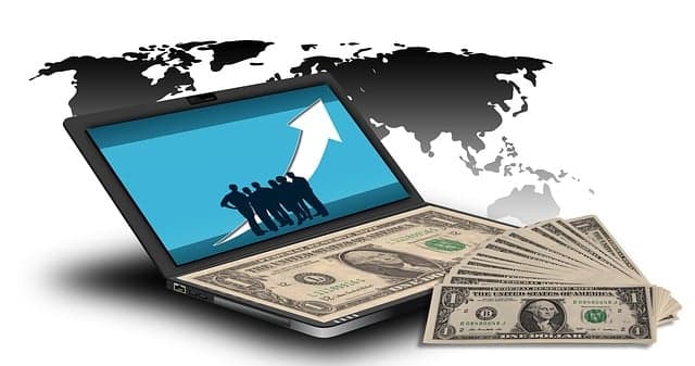 Person working on laptop earning money online with digital tools