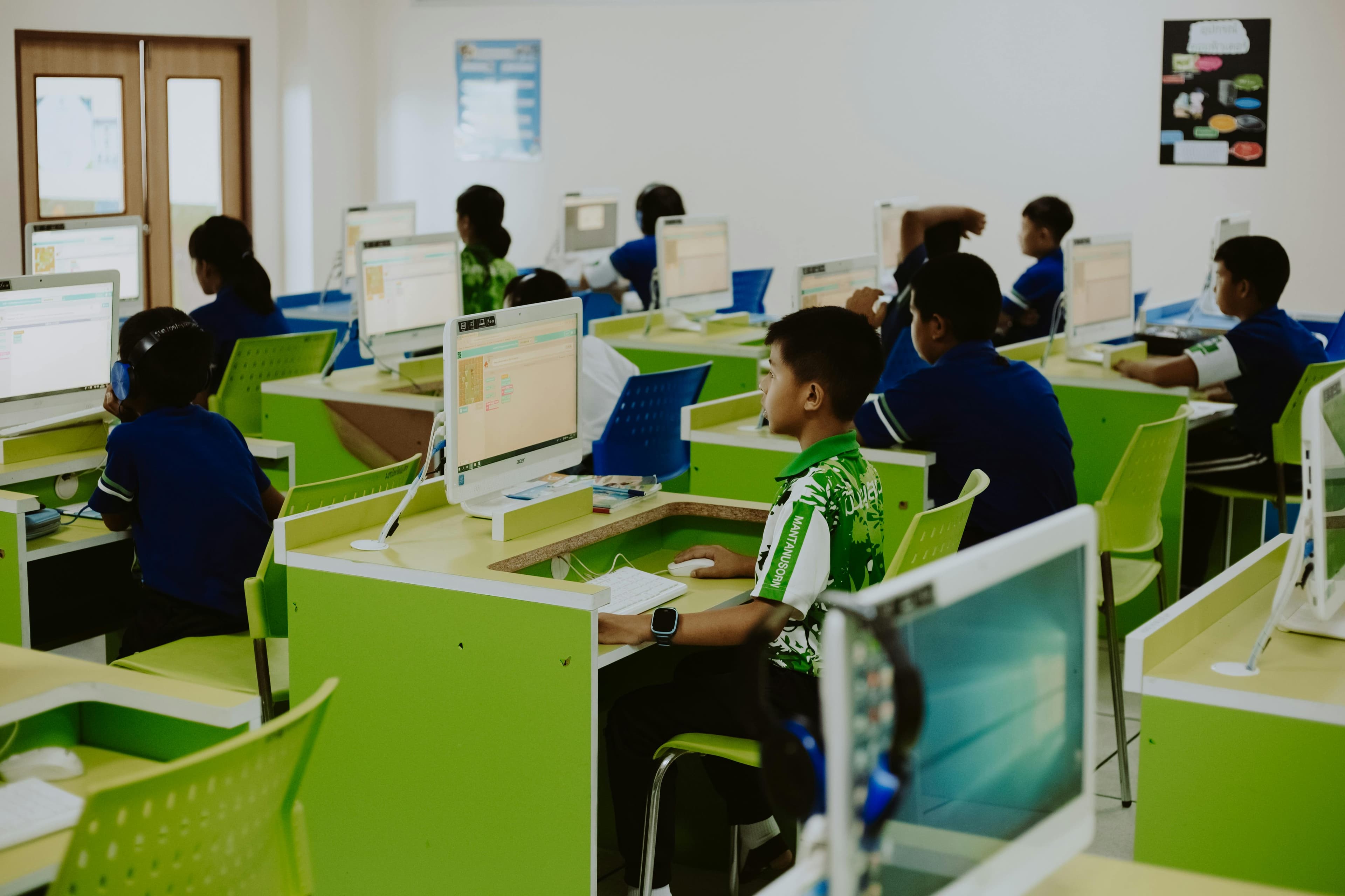 Teacher using laptop and projector in a modern classroom